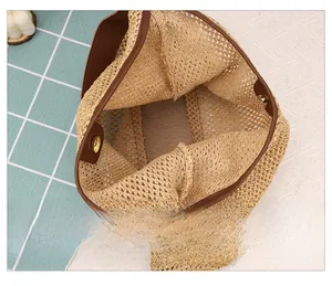 Detail showing inner capacity with magnetic closure of woven straw tote bag
