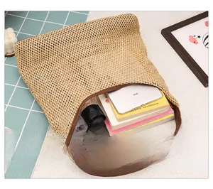 Spacious interior of woven tote bag showing capacity for iPad, books and umbrella