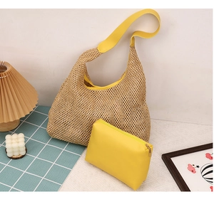 Detail of woven straw hobo bag set with yellow leather trim and matching inner pouch