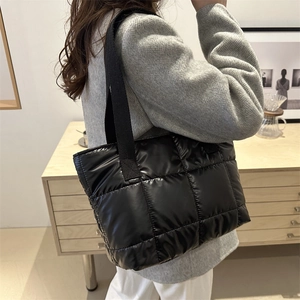 Fashionable black quilted tote bag with wide shoulder strap for 2024 winter casual style