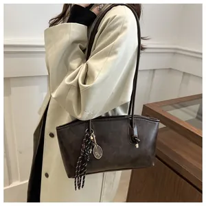 Detail of coffee brown tote bag with FASHION & BAGS text and textured PU leather