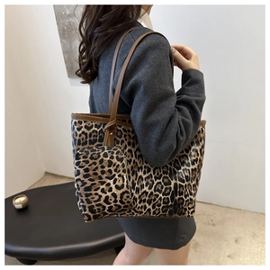 Detail of leopard print tote bag set featuring large shoulder bag and small zipper pouch