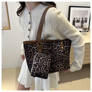 Detailed view of leopard print tote bag with matching zipper pouch and leather straps