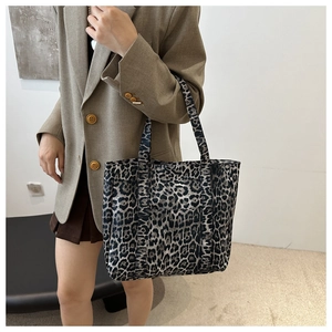 Detail of leopard print tote bag with double shoulder straps and front pocket