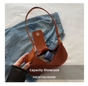 Internal capacity of the brown pleated crescent shoulder bag with daily items