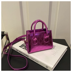 Detailed view of magenta metallic patent leather handbag with diamond quilted pattern