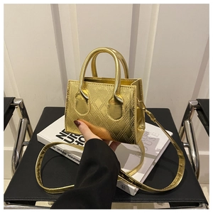 Detail of the golden quilted texture and stitching on this mini leather handbag