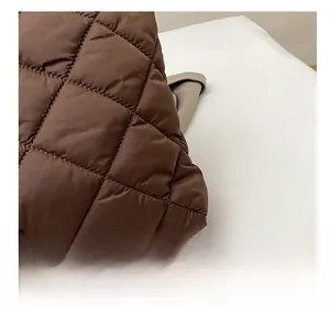 Gros plan sur le cabas matelassé marron foncé montrant la texture surpiquée en losange