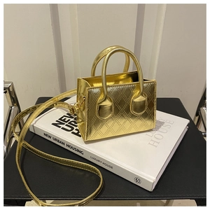 Detail of a small gold metallic crossbody bag with classic quilted diamond pattern