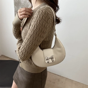 French crescent moon bag in creamy white leather with a silver metal bow accent
