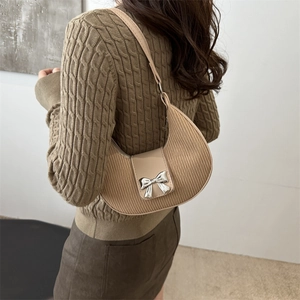 Chic beige pleated crescent shoulder bag with silver metal bow and leather chain strap