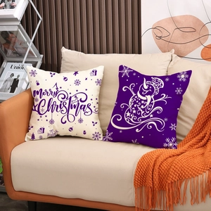 Christmas reindeer and snowman linen pillow covers displayed on a sofa with cozy orange blanket