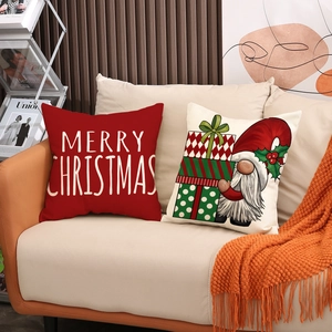 Christmas cushion set with red Merry Christmas text and festive gnome on beige sofa