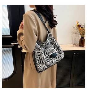 Detail of the black and white geometric pattern fabric on a spacious shoulder bucket bag