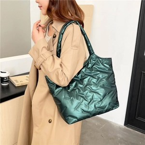 Dark green metallic quilted tote bag with spacious design for winter office commuting
