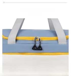 Close-up of blue and yellow fitness bag featuring dual zippers and durable woven handles