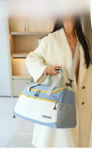Detail of waterproof nylon travel bag showing stitching and blue contrast color