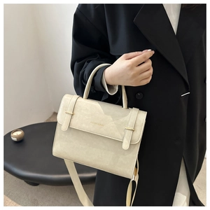 Sac cabas chic en cuir crème avec finitions dorées élégantes dans un cadre lifestyle