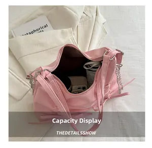Pink shoulder bag showing large interior capacity with phone and cosmetics