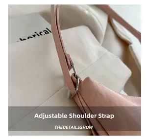 Detailed close-up of pink bag featuring adjustable shoulder strap with silver buckle