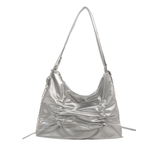 Silver metallic hobo tote bag with pleated detail and bow accents on white background