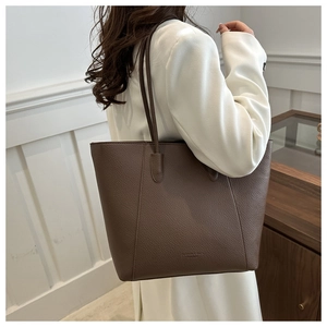 Brown litchi texture tote bag shown on model for daily commuting and fashion use