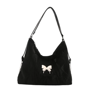 Y2K style black pleated crossbody bag with large white butterfly ornament and slim strap