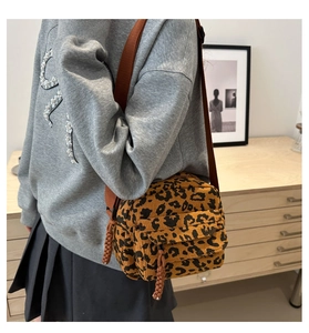 Detailed texture of leopard print corduroy crossbody bag with adjustable strap