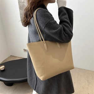 Minimalist beige pebble leather tote bag for women with spacious interior and shoulder straps
