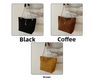 Three suede shoulder bags in black, dark brown, and tan with gold chain and deer pendant