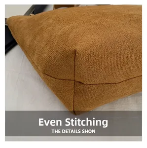 Close-up of precise stitching on vintage brown textured fabric tote bag base