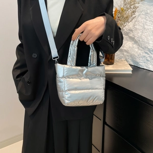 Chic silver quilted puffer handbag with adjustable blue strap for women's winter fashion