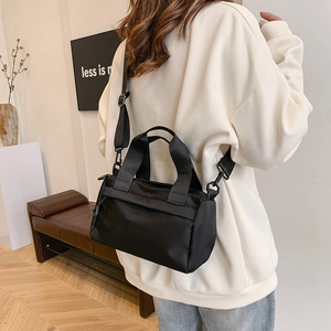 Versatile black nylon shoulder bag with adjustable strap and large capacity for fitness