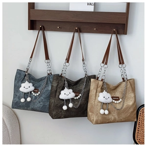 Vintage tote bags with pearl and cloud charms in blue, brown, and tan colors