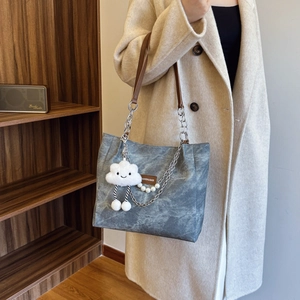 Gray marble tote bag with pearl chain and cloud charm shown in lifestyle home setting