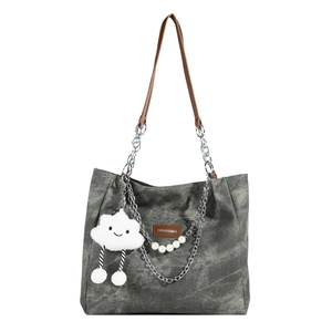 Minimalist grey washed canvas tote bag with brown leather handles and cloud pendant