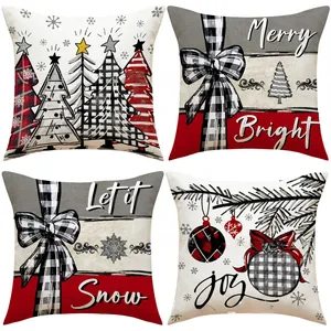Close-up of four Christmas pillow covers with buffalo plaid and holiday tree patterns