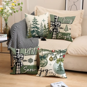 Set of four Christmas tree throw pillow covers in cream and green on a sofa