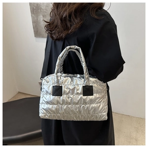 Detailed back view of a silver quilted puffer tote bag with black shoulder straps