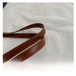 Close-up of a brown lychee-patterned leather strap with double stitching and oil edges