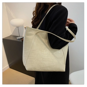 Off-white crocodile pattern tote bag shown on model for high-capacity daily commute