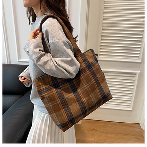 Detailed view of the vintage plaid pattern and textured wool material on this tote bag