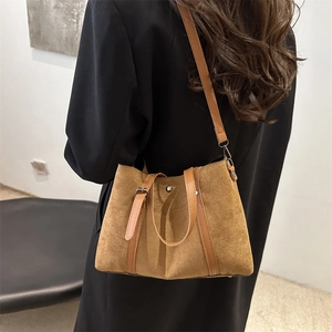 Brown frosted large tote bag with top handle and shoulder strap shown on model coat