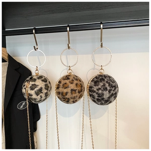 Three leopard print spherical evening bags with metal ring handles and gold chains
