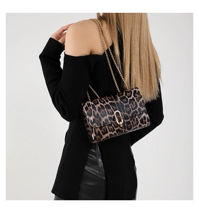Detail of leopard print flap bag with gold metal U-shaped buckle and chain strap