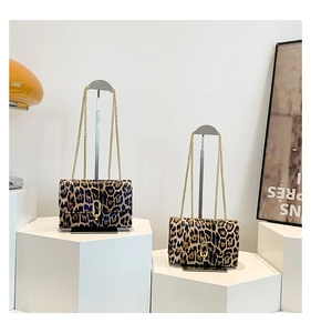 Detail of leopard print chain shoulder bags in two sizes with gold metal hardware