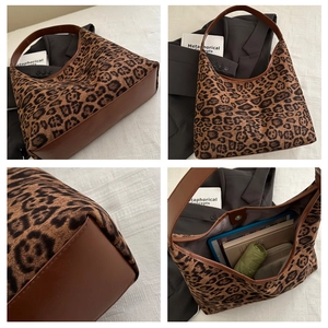 Detail showing the spacious interior of a leopard print hobo bag with daily essentials