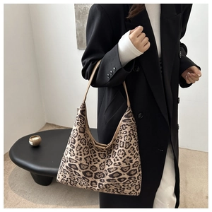 Detail of leopard print hobo bag showing large capacity and textured fabric on shoulder