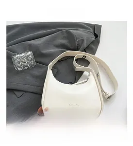 Detail of cream hobo shoulder bag with New York print on textured faux leather