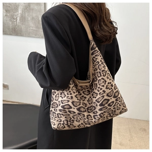 Close-up of stylish leopard print tote bag worn on shoulder for casual commute fashion